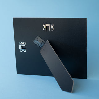 black landscape picture frame strut on blue background