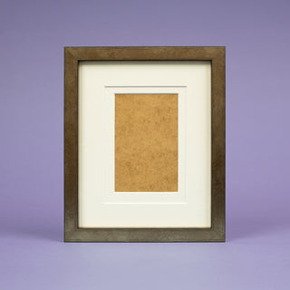 bronze picture frame on a light purple background with a cream mount