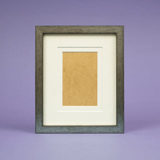 classic worn pweter portrait picture frame on a purple background