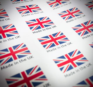 Pattern of 'Made in the UK' labels with Union Jack flags on a white background