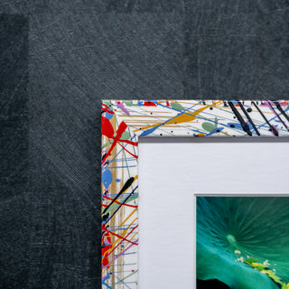 Colorful abstract patterned picture frame on a dark textured background