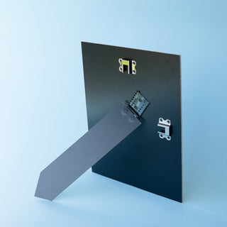 Back of a picture frame strut in black standing portrait