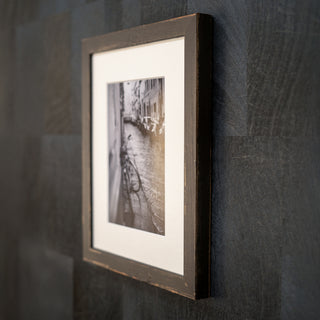 Framed photograph on a textured dark wall